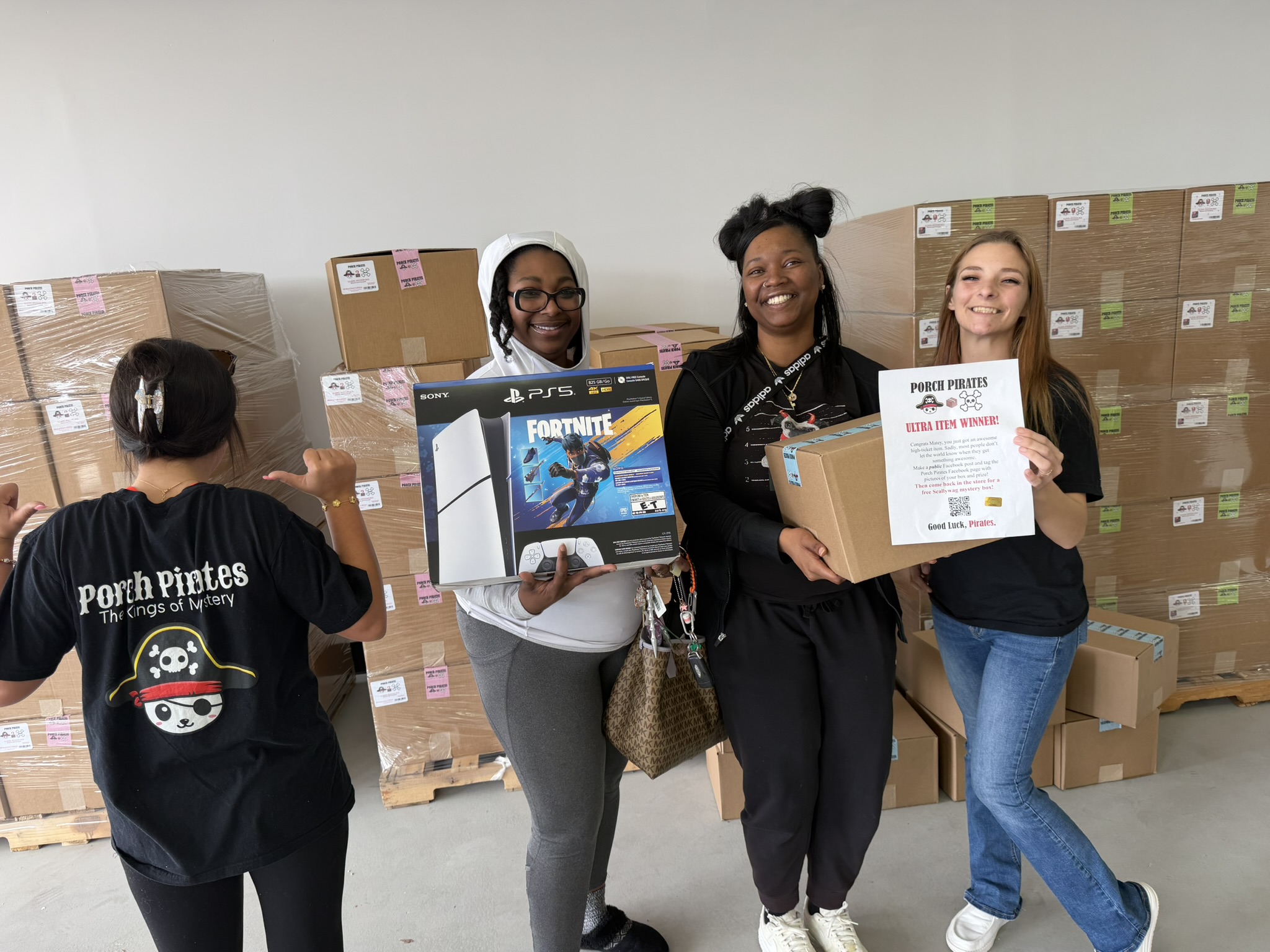 Customers with a PS5 bundle and the crew showing off the Ultra Item Winner sign