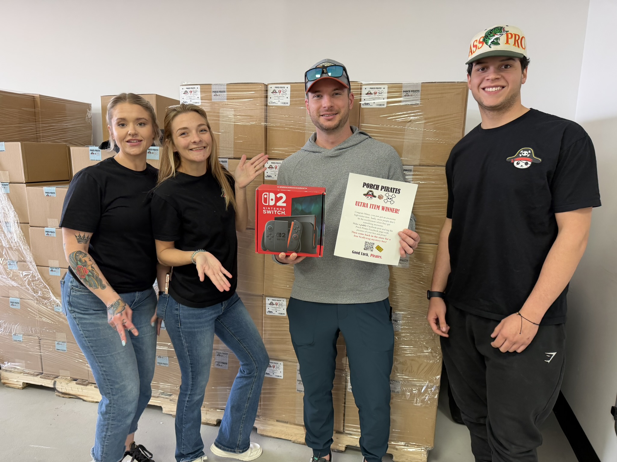 Customer holding a Nintendo Switch 2 and a winner sign with the crew