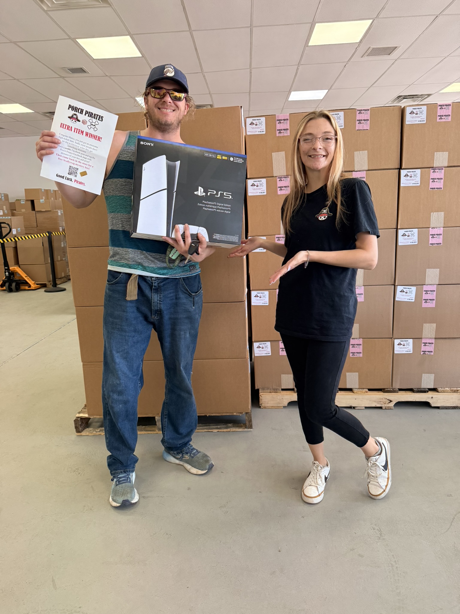 Customer holding up a PS5 and an Ultra Item Winner sign