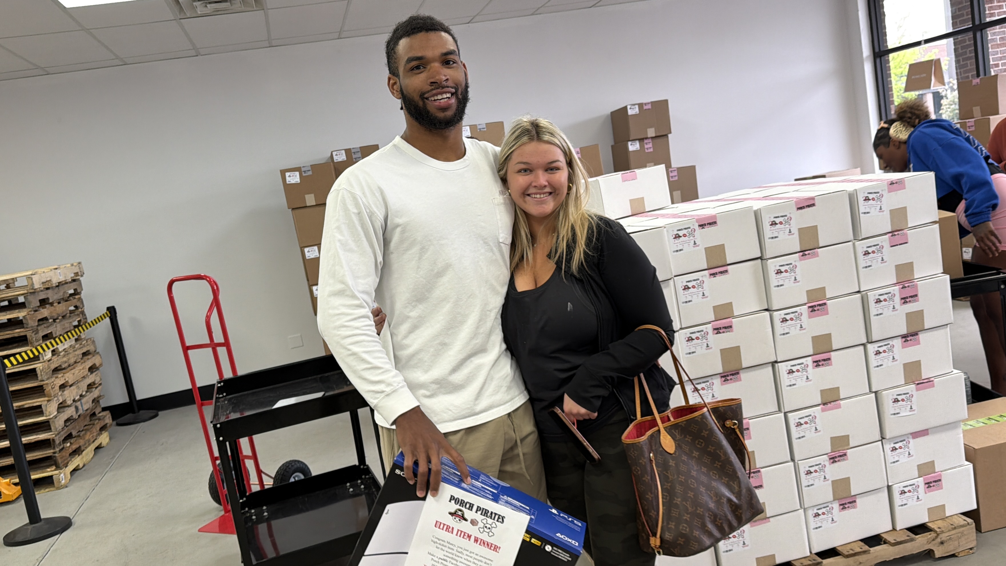 Couple with a PS5 and a Louis Vuitton tote