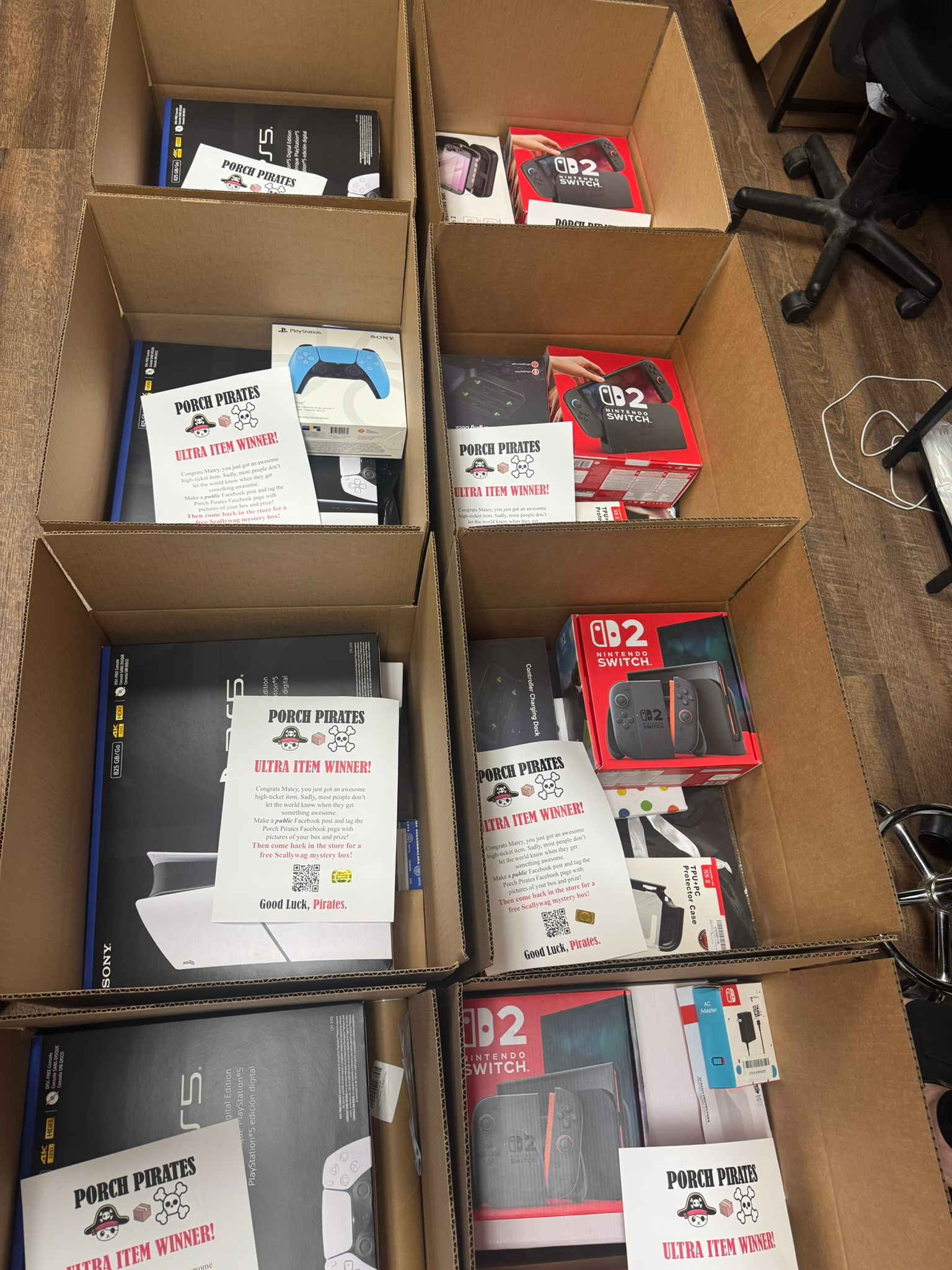 Prize boxes being packed with a Switch 2, game controllers and winner sheets