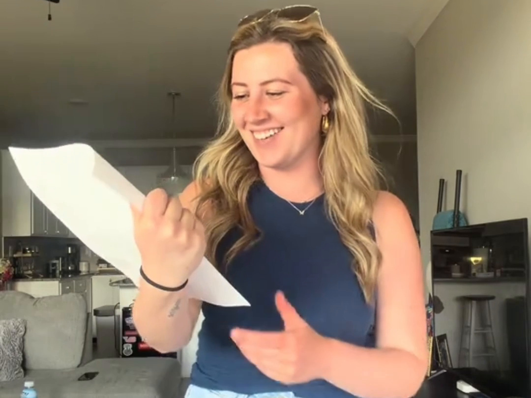 Customer at home laughing as she reads her Ultra Item Winner card